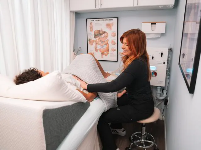 Certified therapist caring for a client during a colon hydrotherapy session